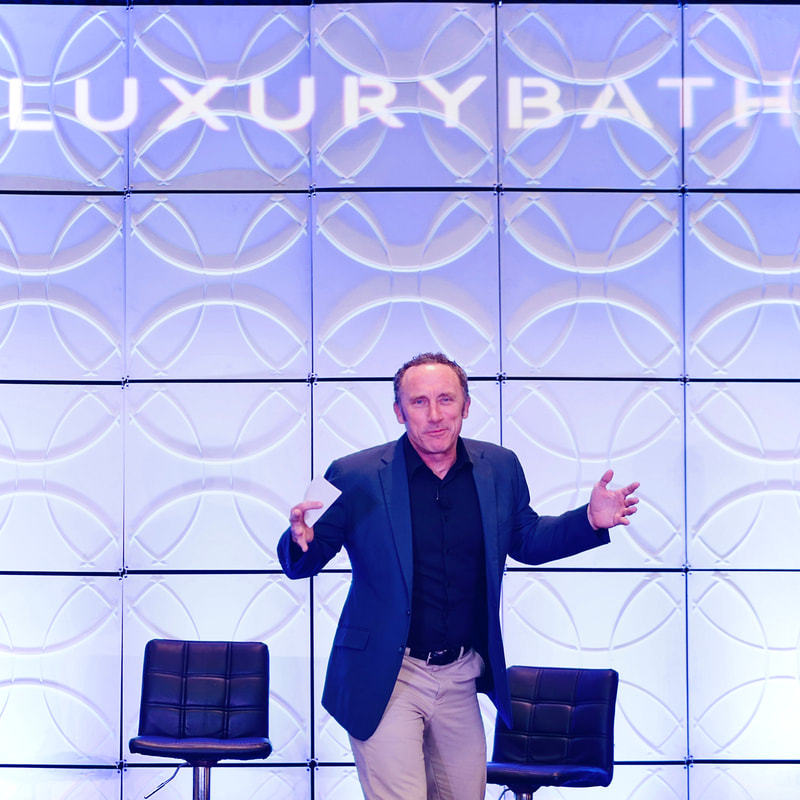 Joel Bryant emceeing a multi-day corporate sales conference for Luxury Bath and Bath Planet