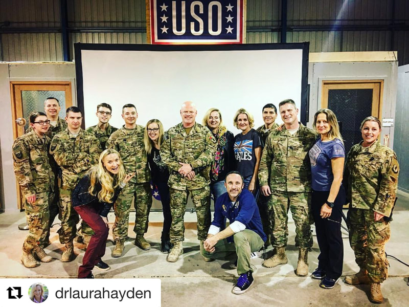 Joel Bryant, standup comedian, poses with soldiers and other comedians at the USO at Bagram Air Base in Afghanistan