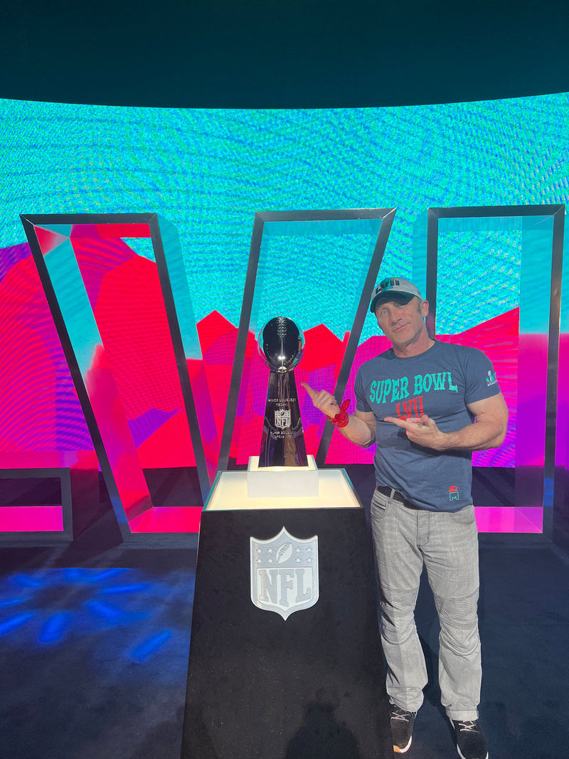 Posting with Lombardi trophy at the Super Bowl Experience in Glendale Arizona for Super Bowl LVIII